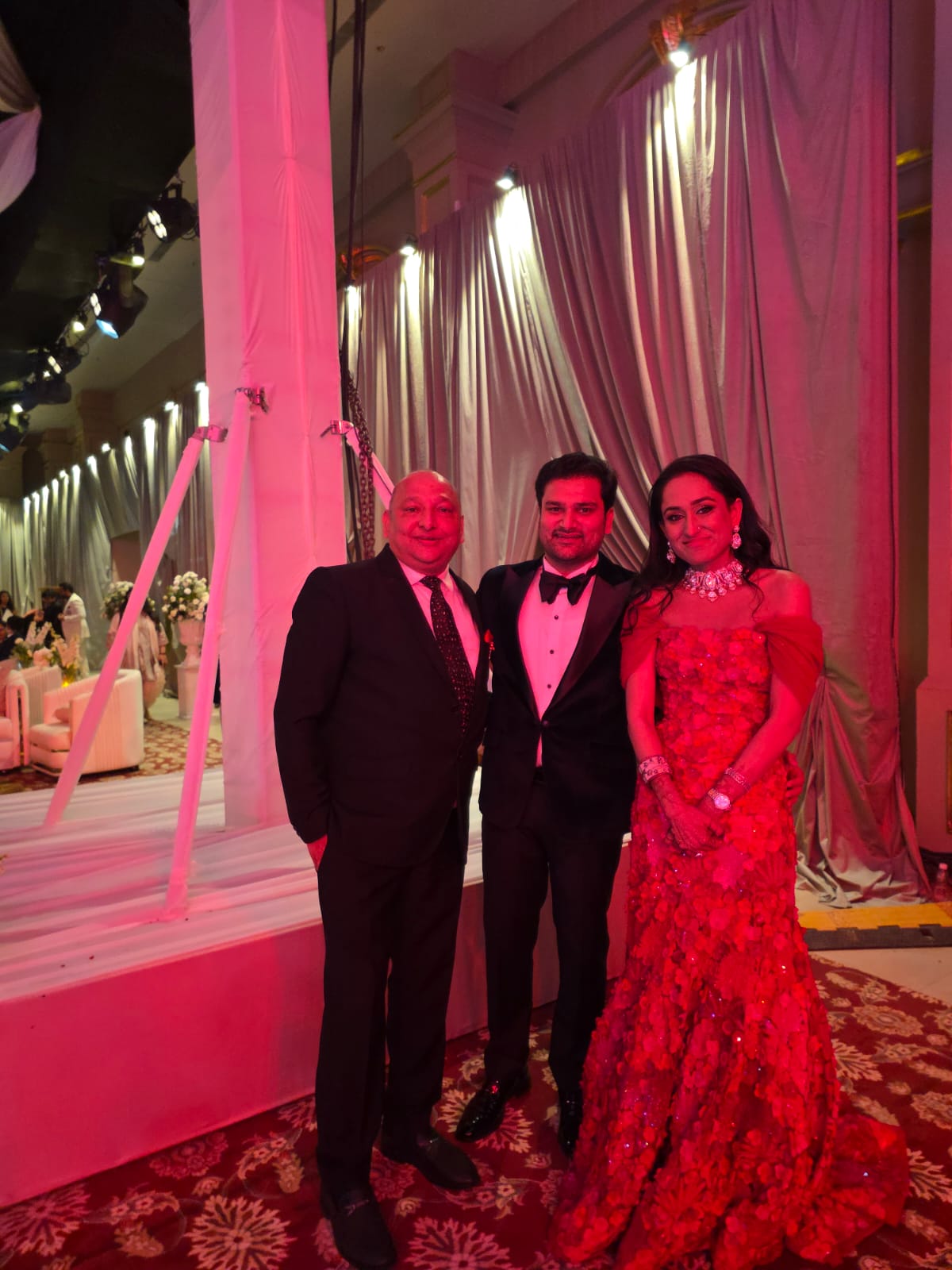 Manoj Garg with a couple at an evening celebration