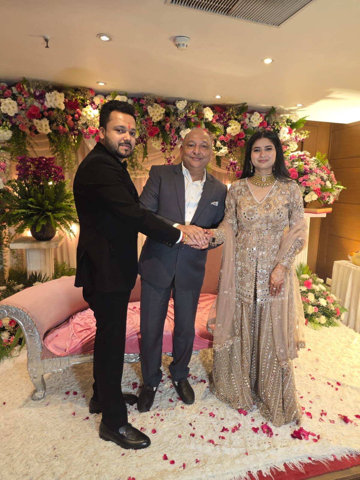 Manoj Garg with a couple at their wedding celebration