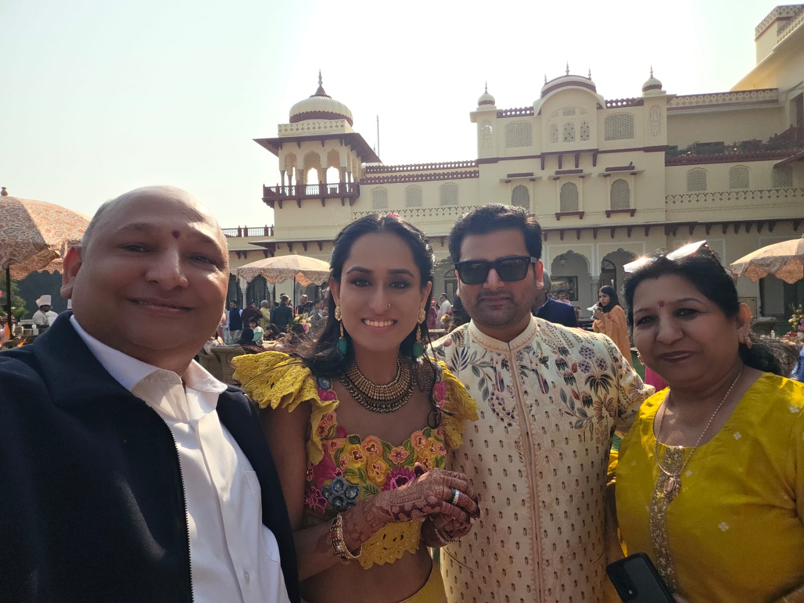 Manoj Garg with a couple and family member at a daytime wedding